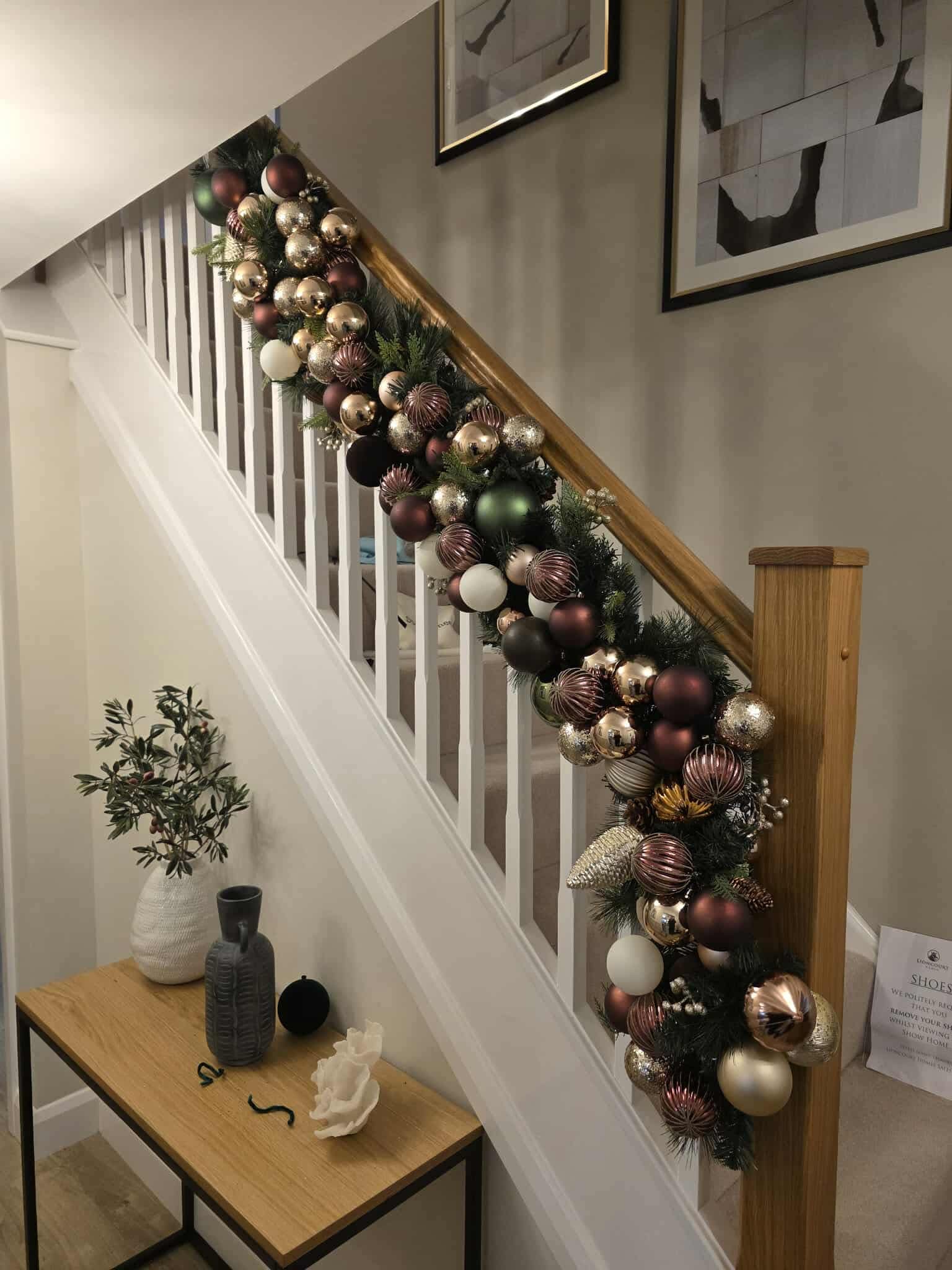 Staircase garland with baubles in a home hallway, Worcestershire