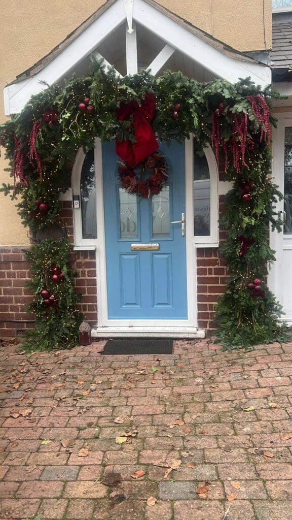 Christmas wreath and porch garland on a home front door, Worcestershire