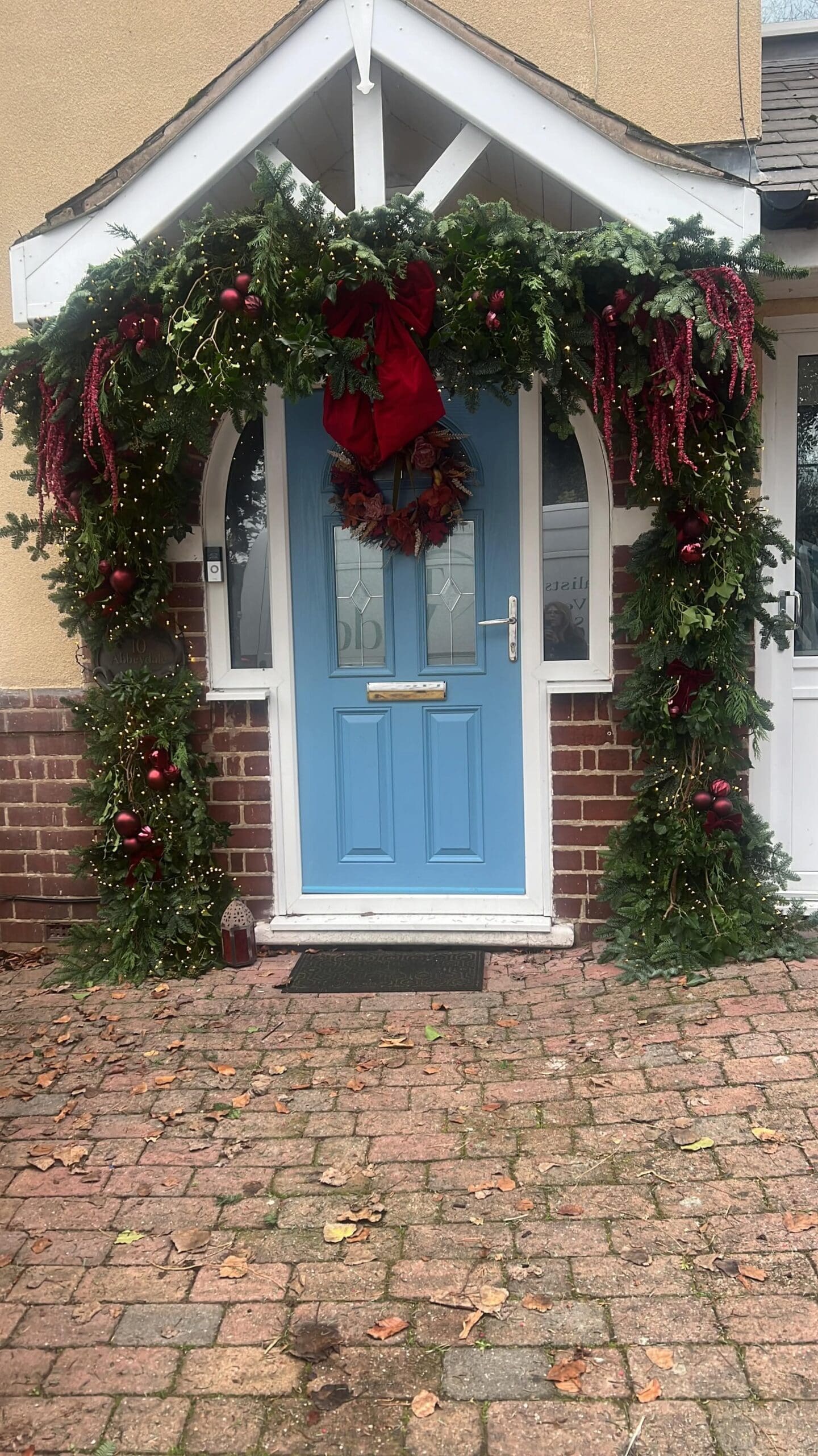 Christmas wreath and porch garland on a home front door, Worcestershire