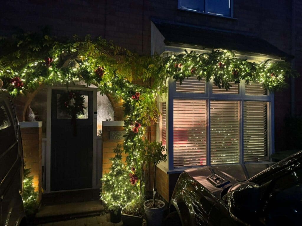 Outdoor Christmas garland and lighting on a home entrance, Worcestershire