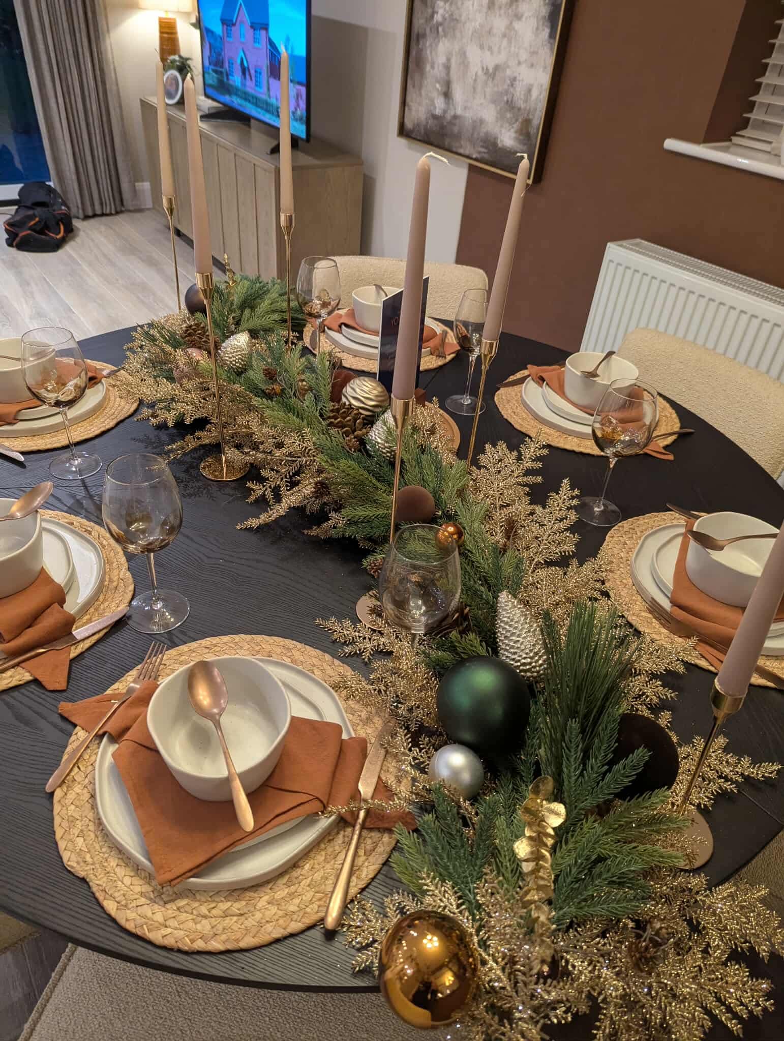Christmas table setting with pine garland and candles, show home styling